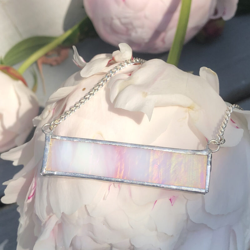 Beautifully hand-crafted pink and white wispy iridescent stained glass bar necklace. 2"x 0.5"
